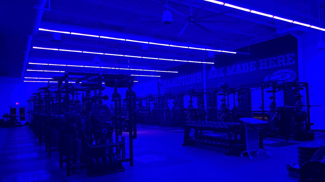 Indigo-Clean technology in use at Chelsea High School&apos;s weight room, in Michigan. Exercise facilities have been considered high-risk for transmission of harmful bacteria because of their enclosed environment, shared equipment, and close contact between users and staff. Clinically proven to reduce harmful bacteria, 405-nanometer lighting technology can be installed to provide continuous disinfection.