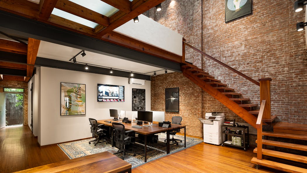 A historic townhouse is converted into an office environment with hints of residential design.