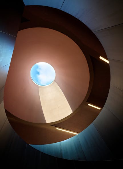 A staggered grid of recessed point sources within the stair volume adds to the sense of mystery while enhancing the skylight, which allows in natural light.